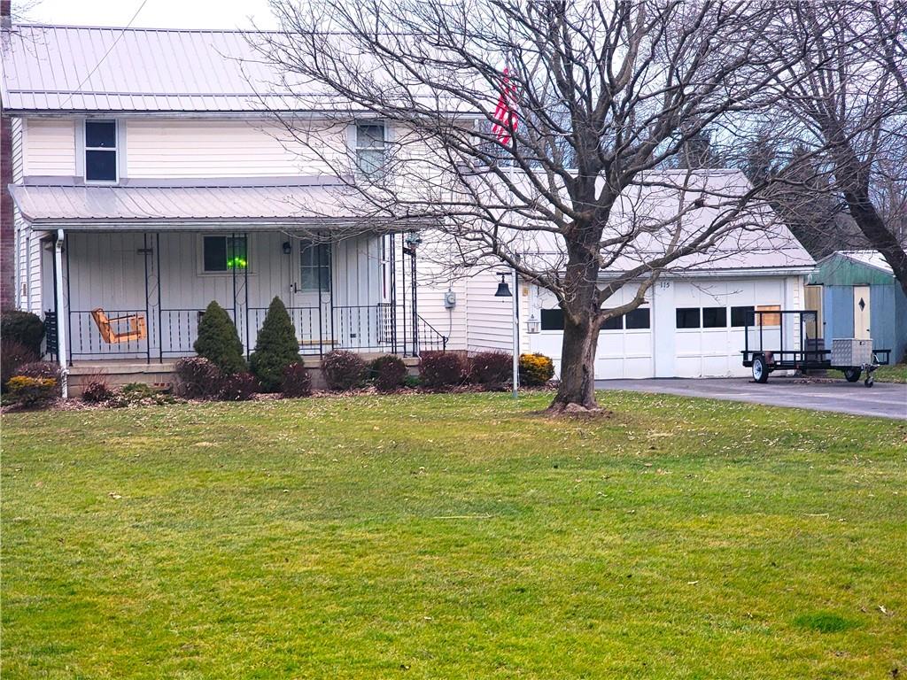 a front view of a building with a garden