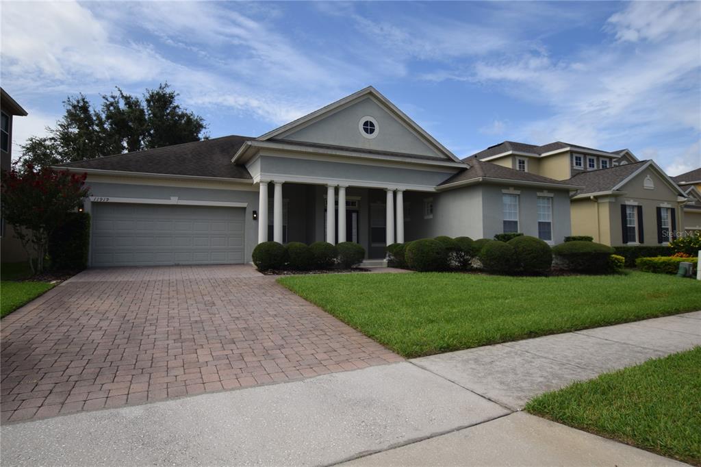 a front view of a house with a yard and garage