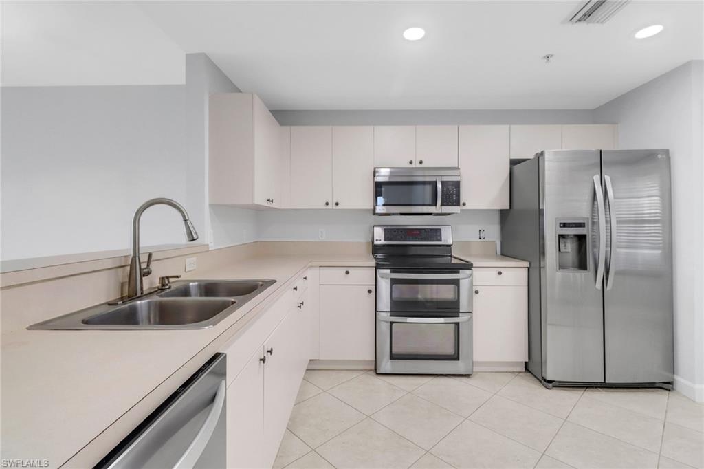 a kitchen with a sink and stainless steel appliances