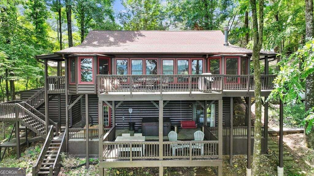 a aerial view of a house with balcony and outdoor seating