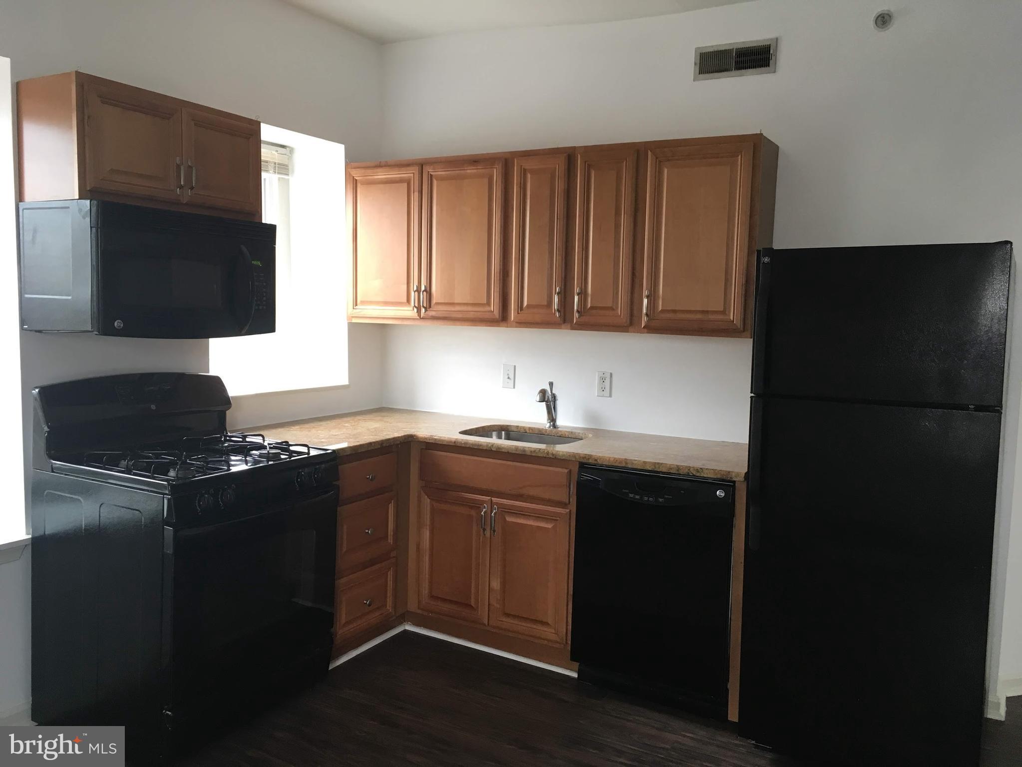 a kitchen with a sink and a refrigerator