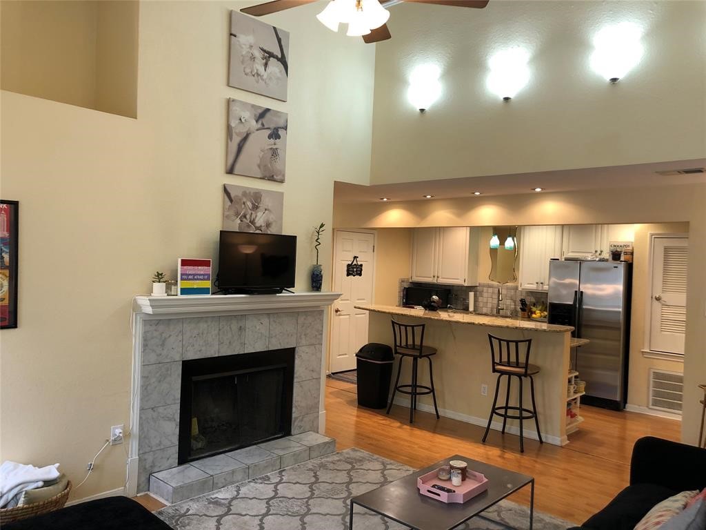 a kitchen with a refrigerator and a fireplace