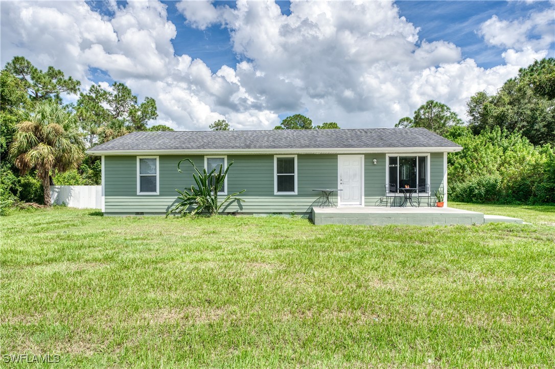 a front view of house with yard and green space