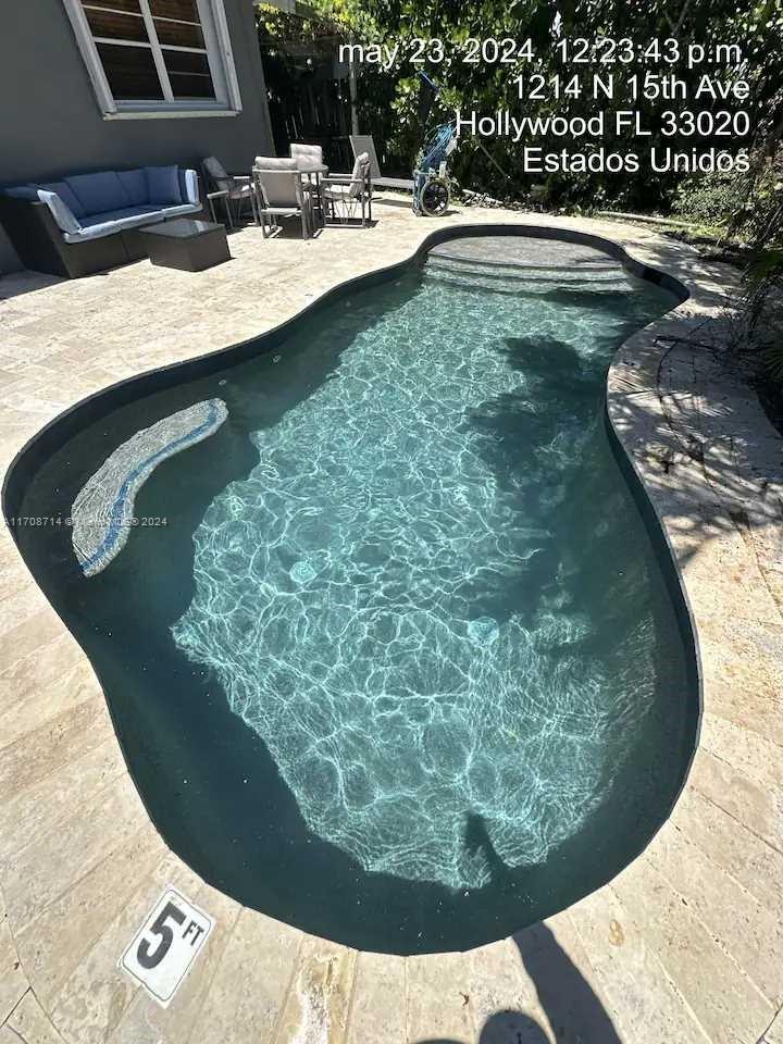 a view of a swimming pool in a backyard