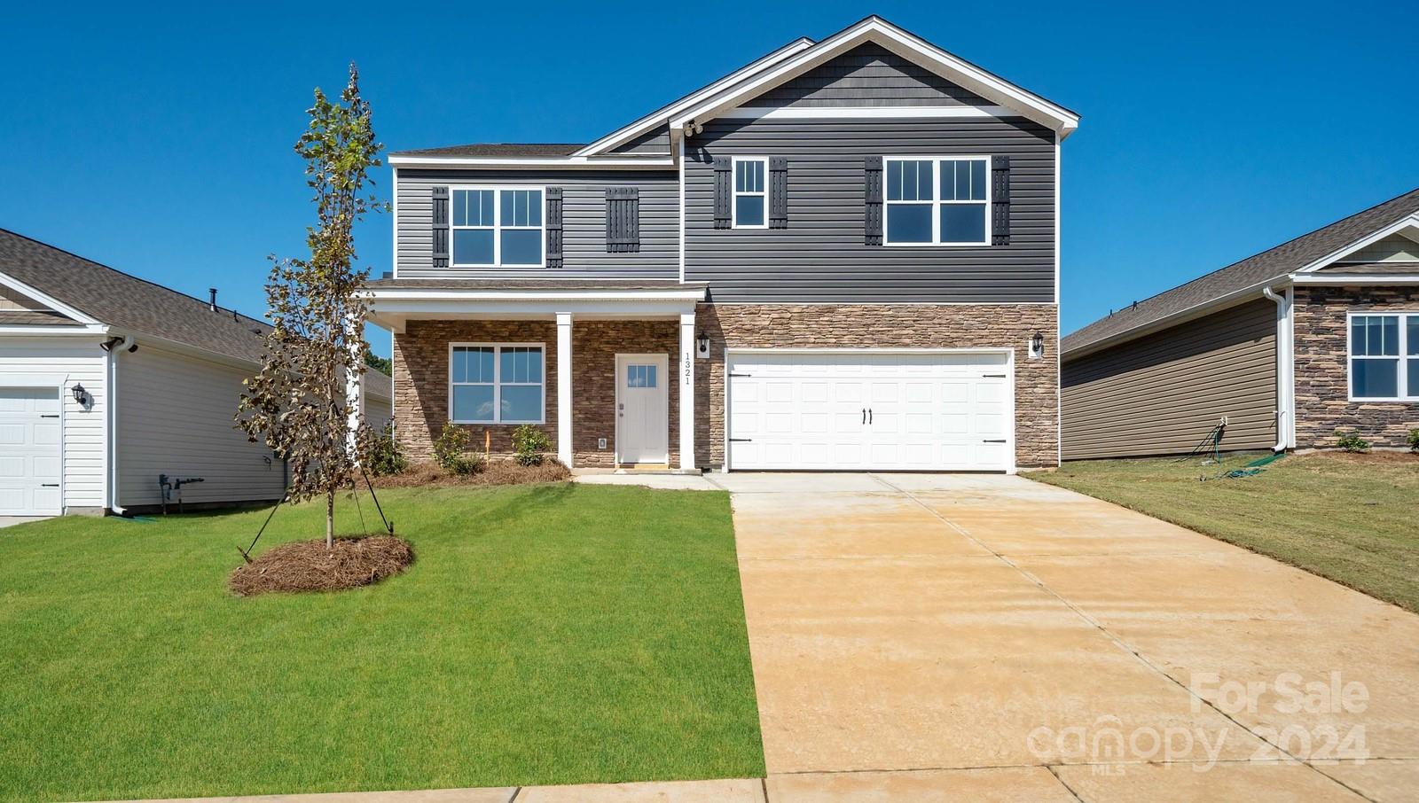 a front view of a house with a yard and garage