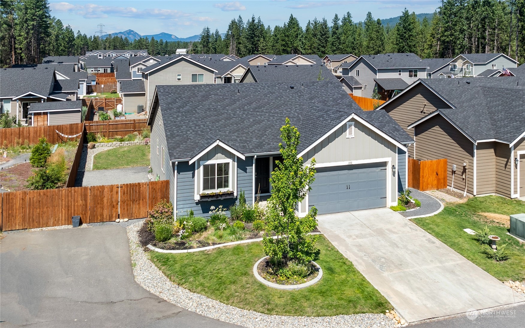 a aerial view of a house next to a yard