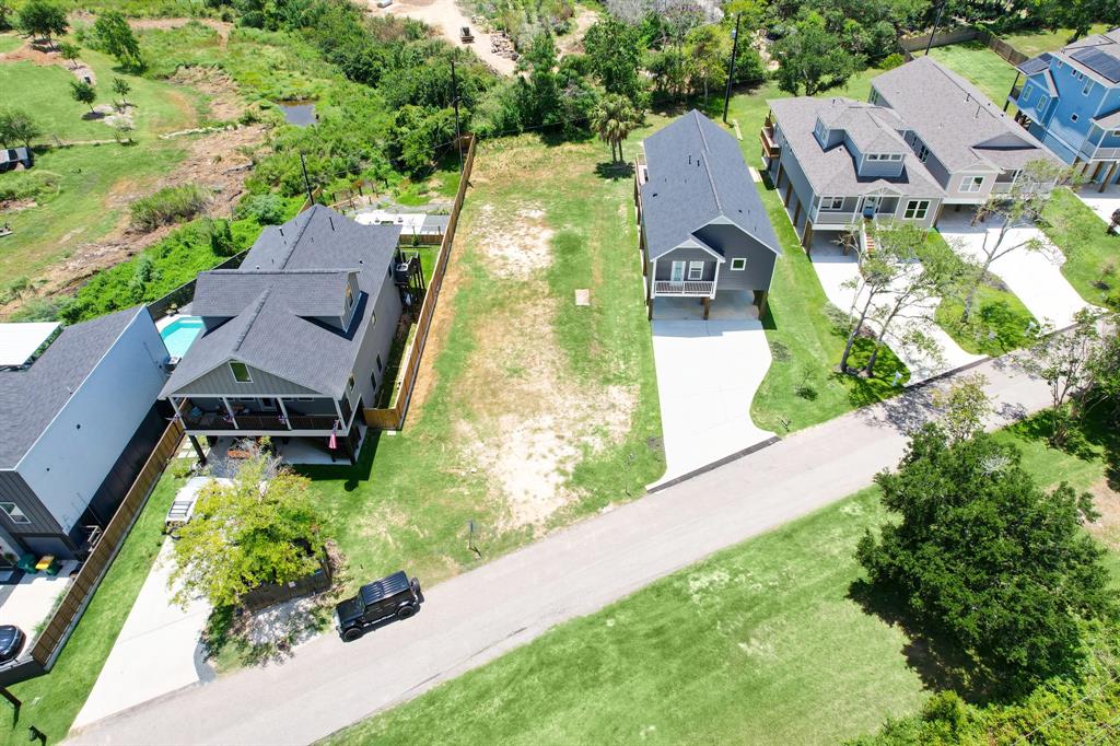 an aerial view of a house with a yard and lake view