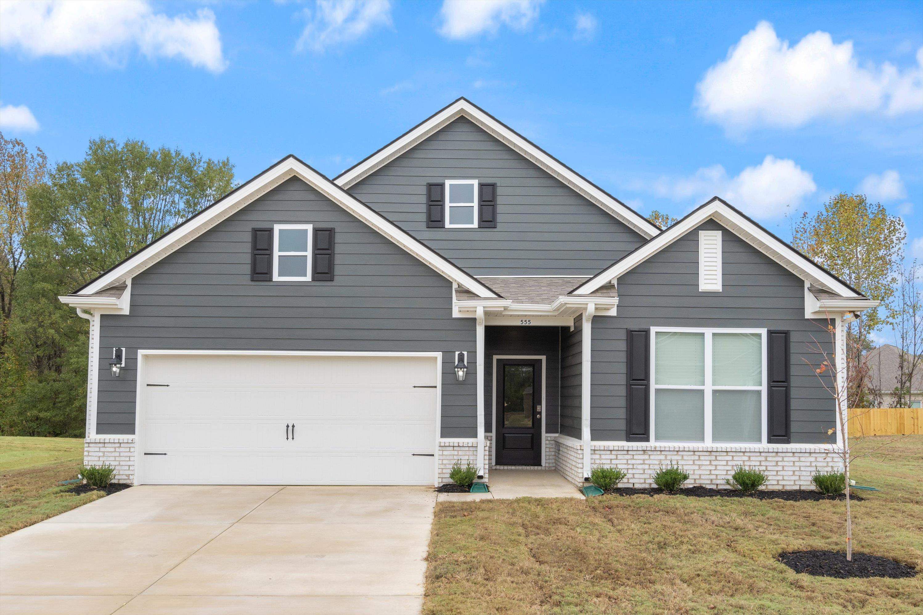 Craftsman-style house with a garage and a front lawn