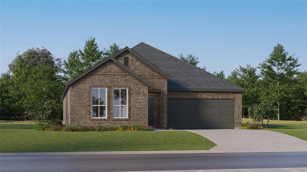 View of front of home featuring a front yard and a garage