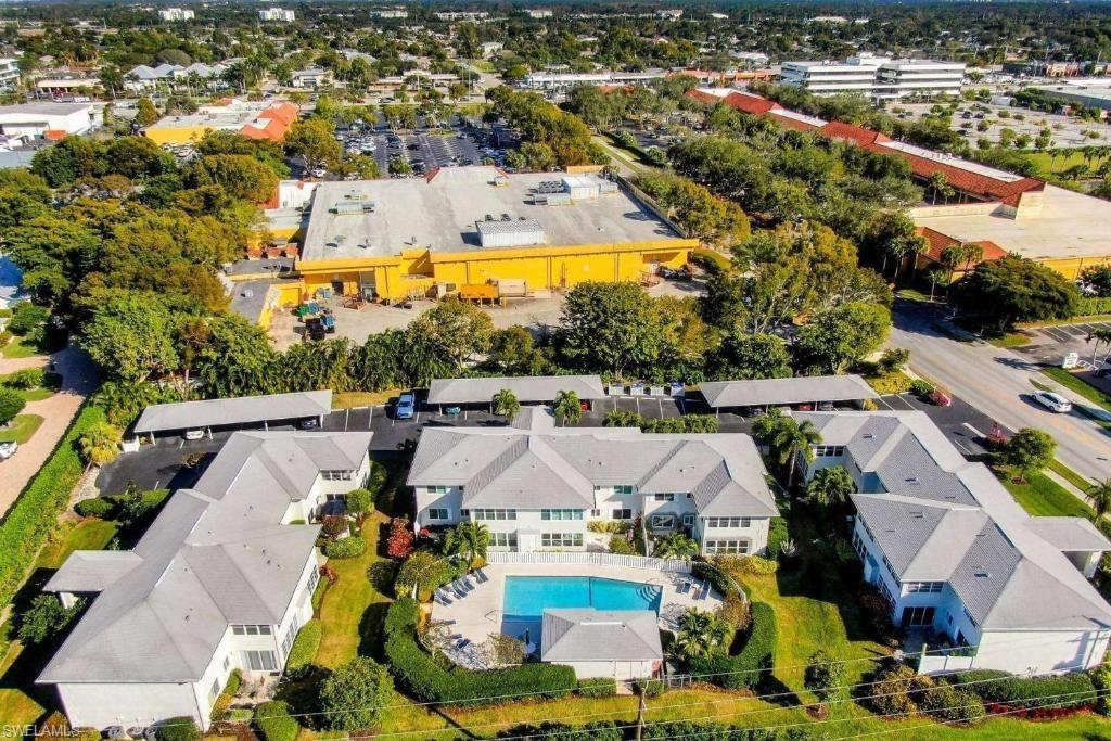 an aerial view of residential houses with outdoor space and swimming pool