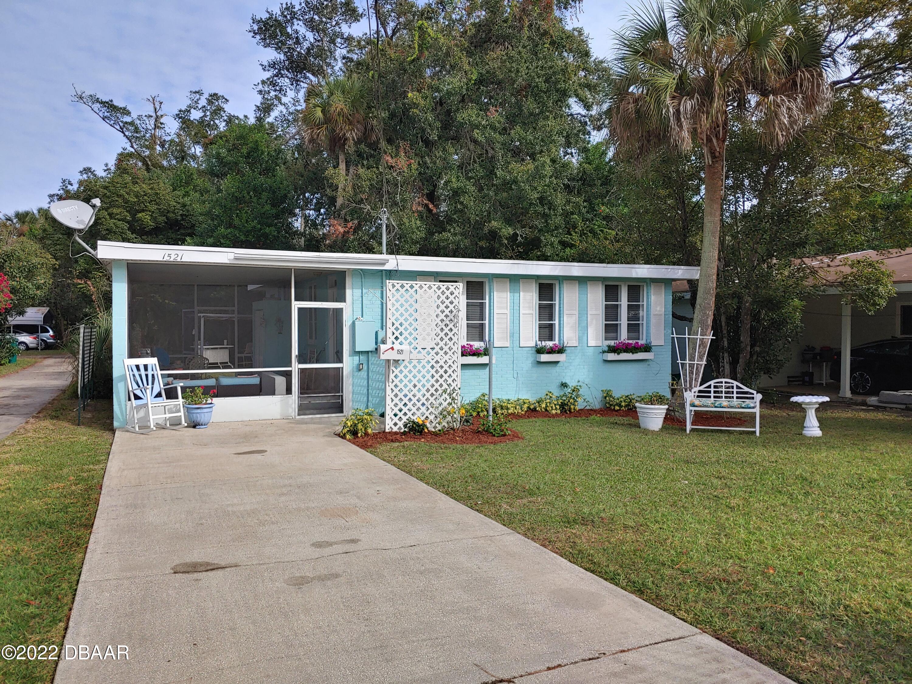 a view of a house with backyard porch and sitting area