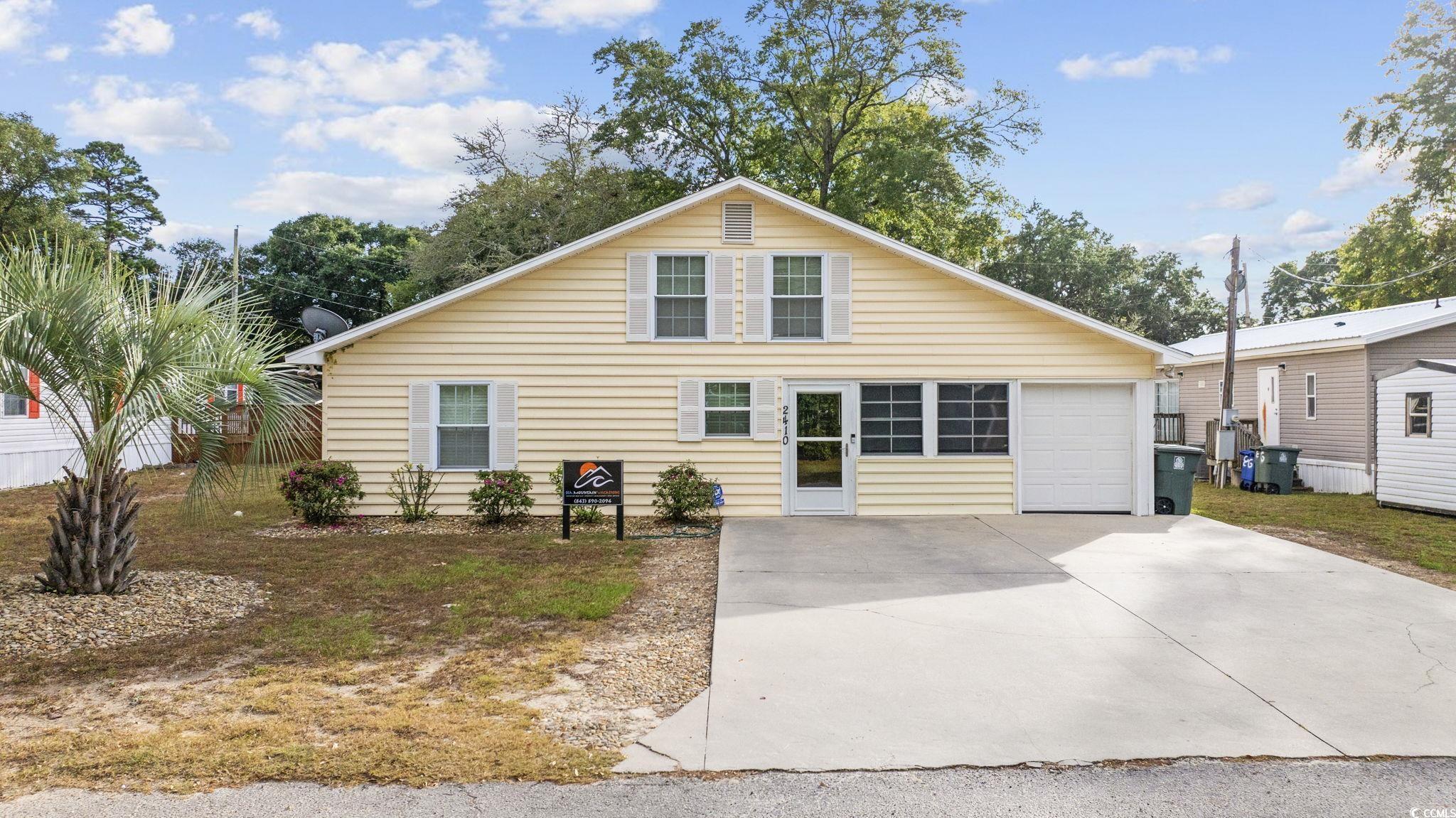 View of front facade featuring a garage