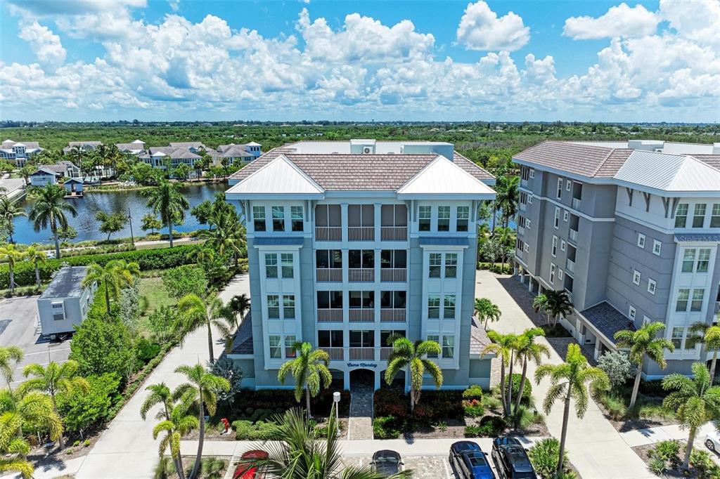 a front view of a multi story residential apartment building with a yard