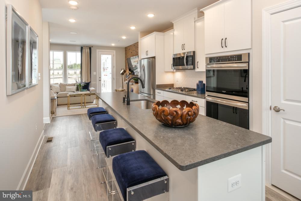 a kitchen with a sink a counter top space appliances and a window