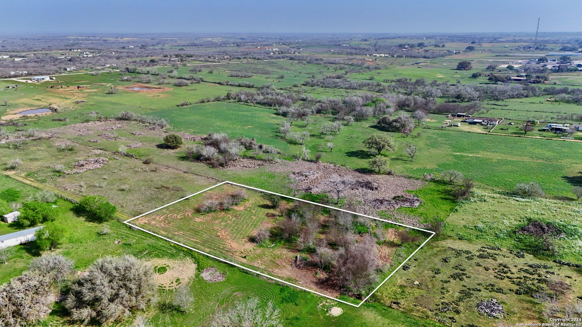 a view of a field with an outdoor space