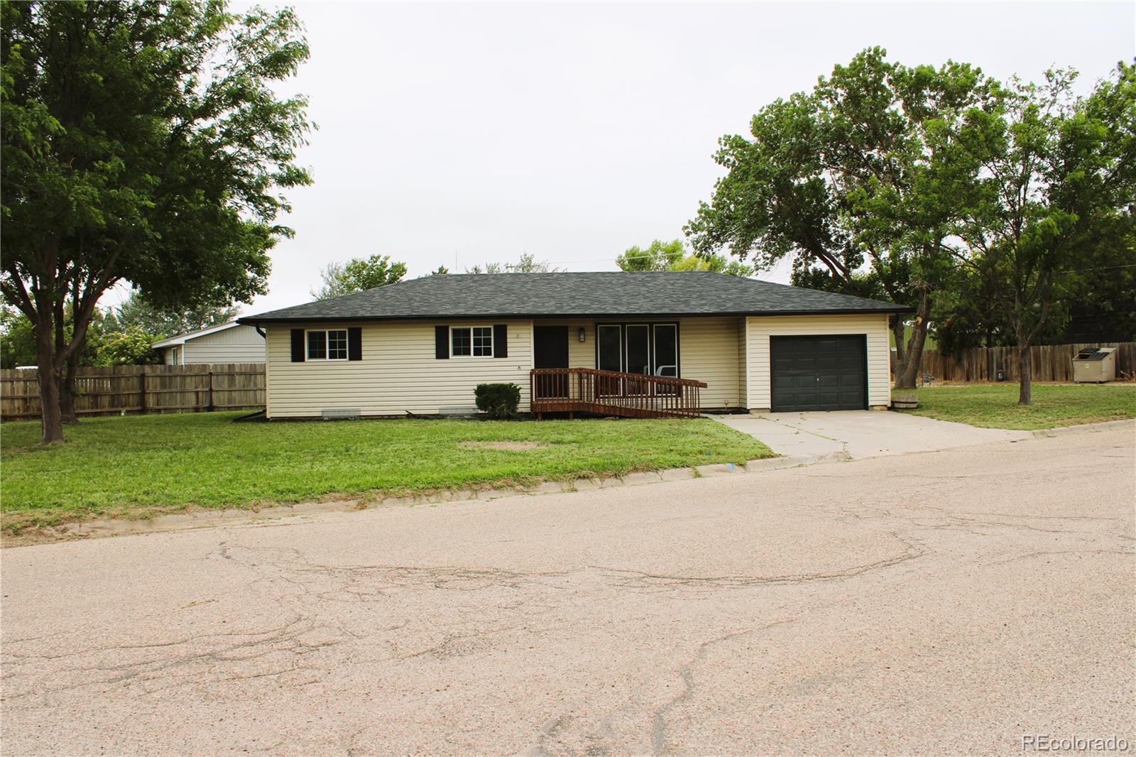 a front view of house with yard and green space