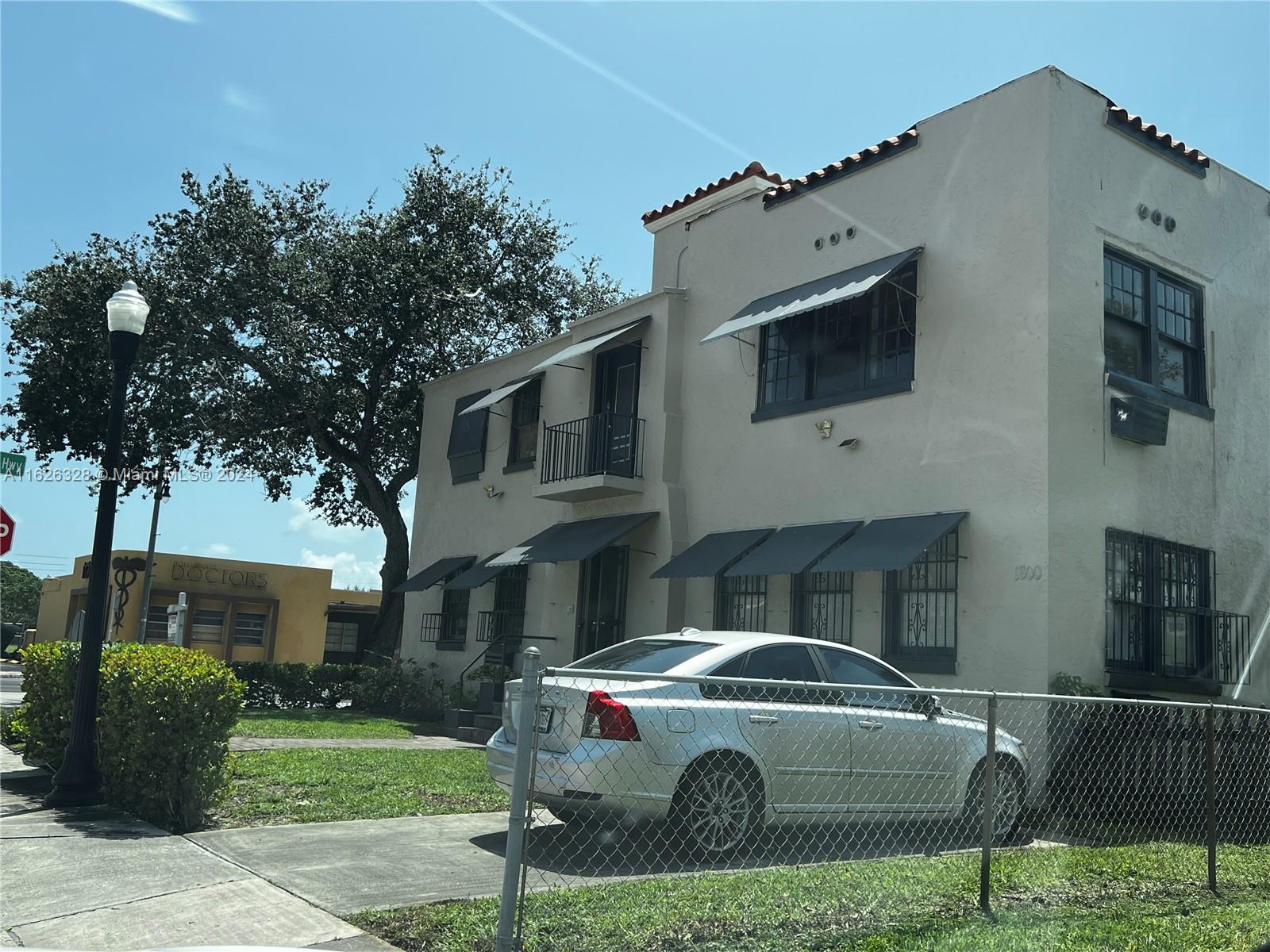 a view of a car parked in front of a brick house