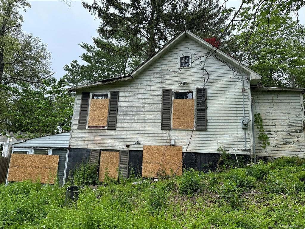 a aerial view of a house next to a yard