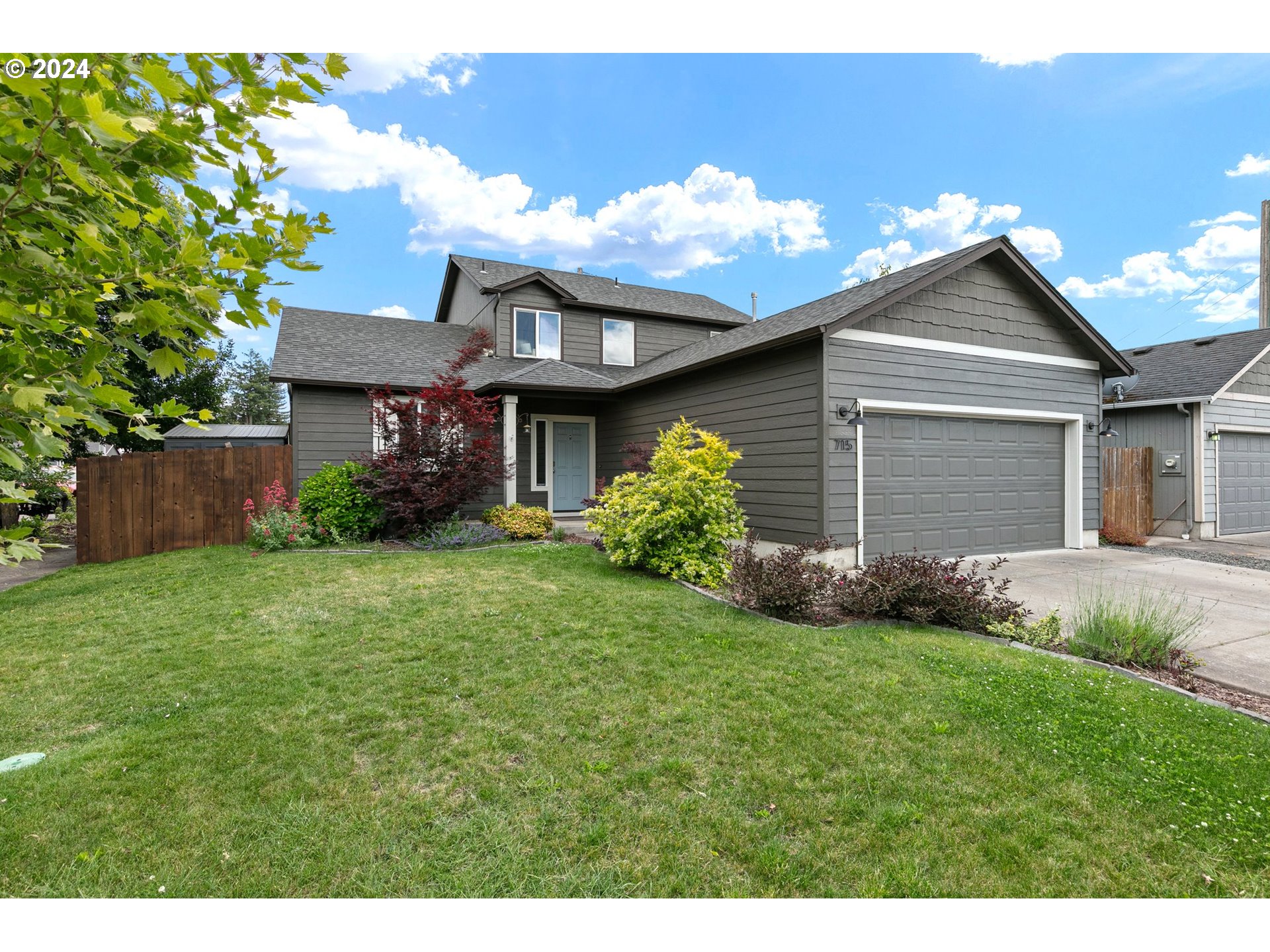 a front view of a house with a yard and garage