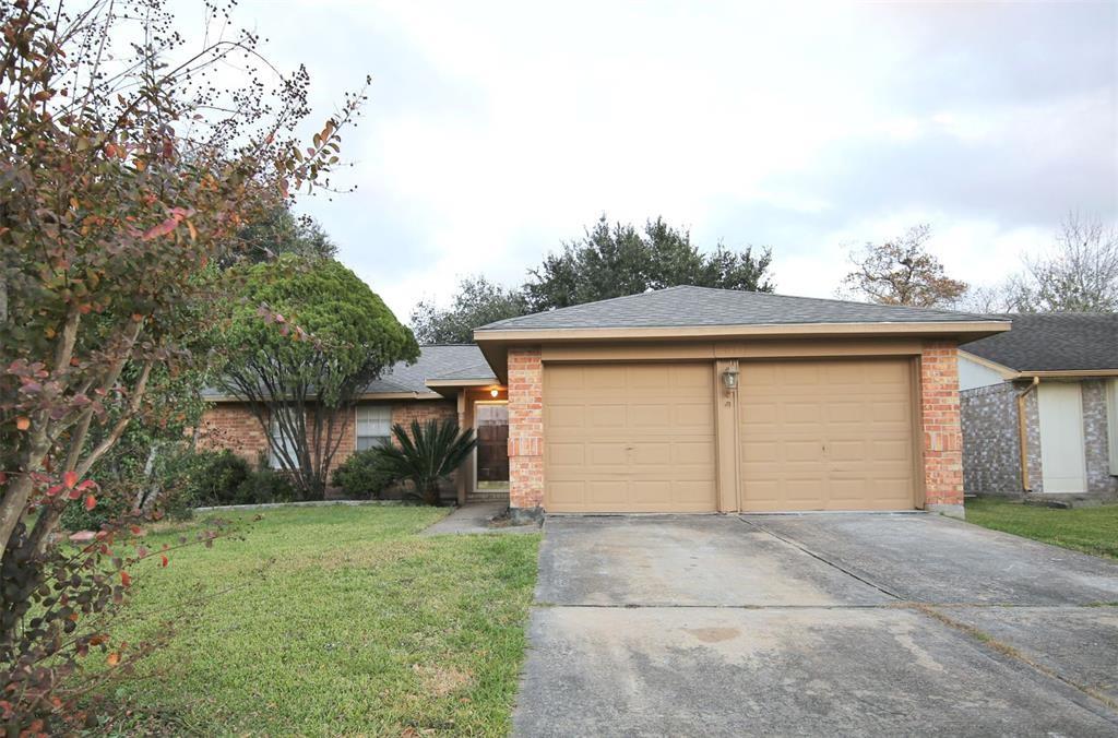 a front view of house with garage and trees