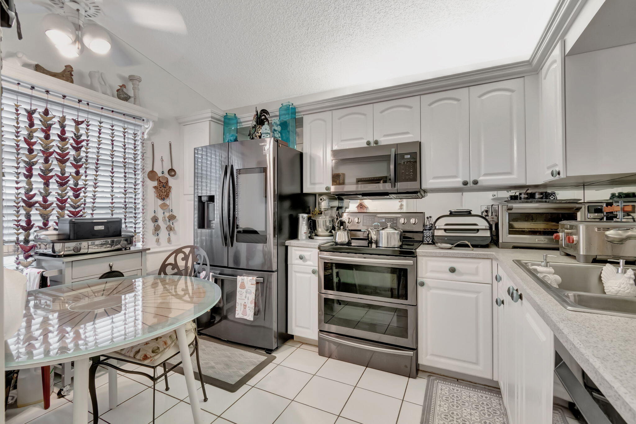 a kitchen with stainless steel appliances a stove refrigerator sink and cabinets