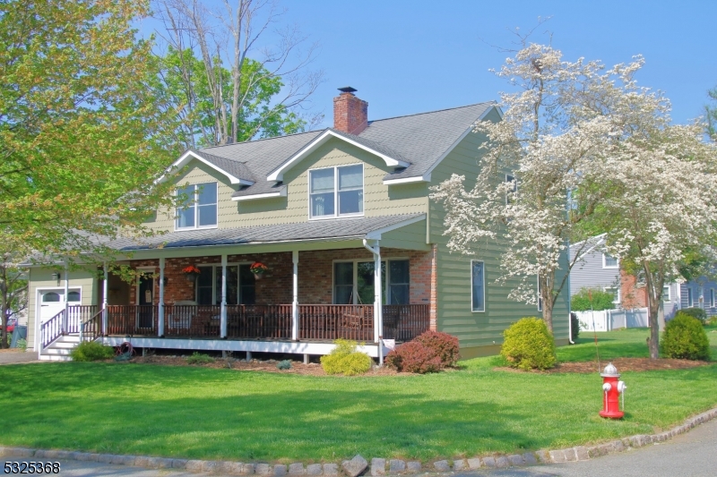 a front view of a house with a yard and porch