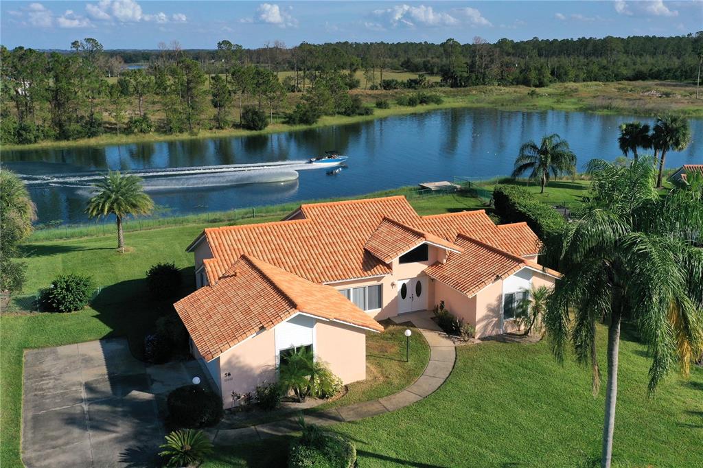 an aerial view of a house with pool and a yard