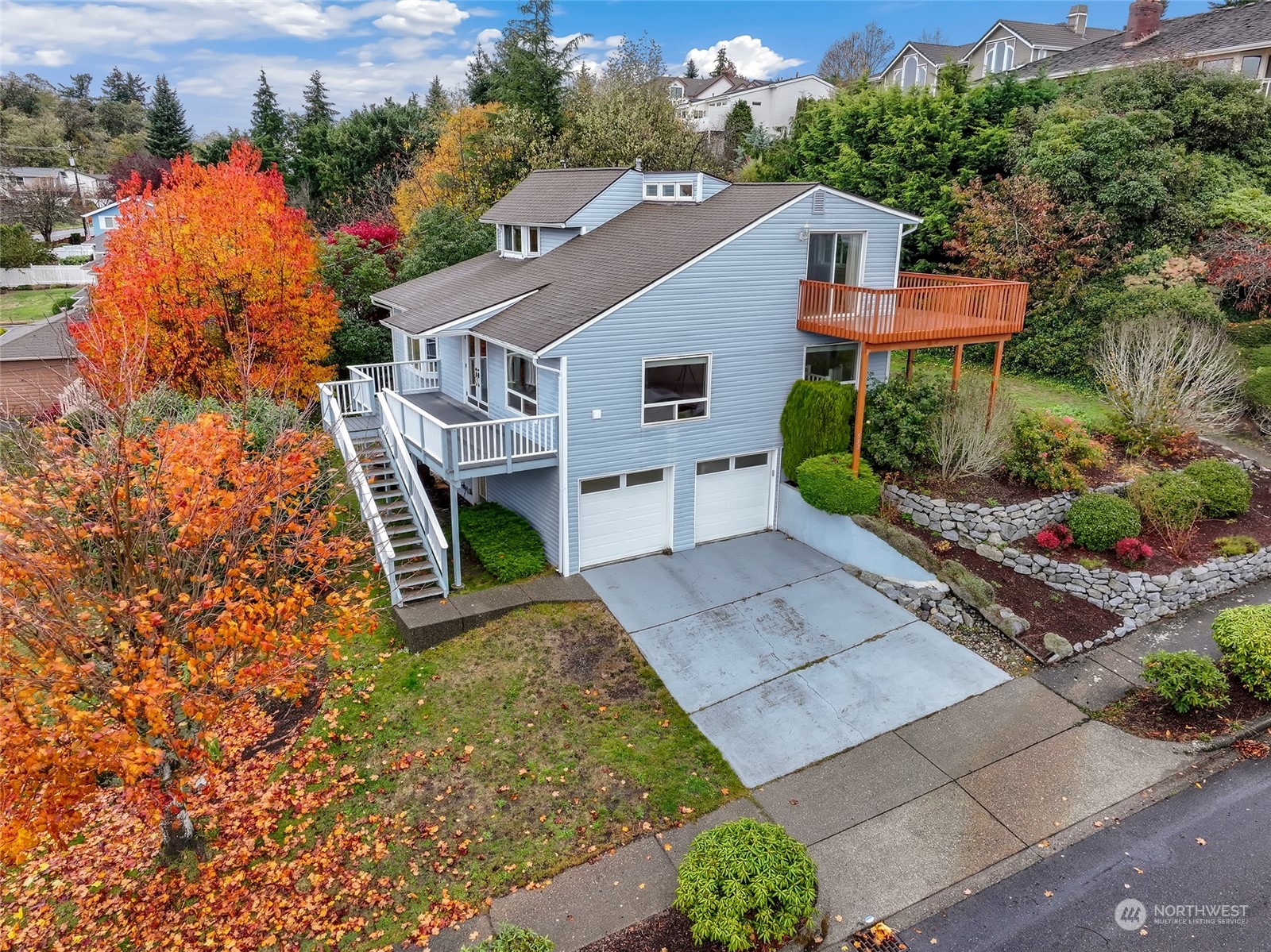 an aerial view of a house with a yard and potted plants