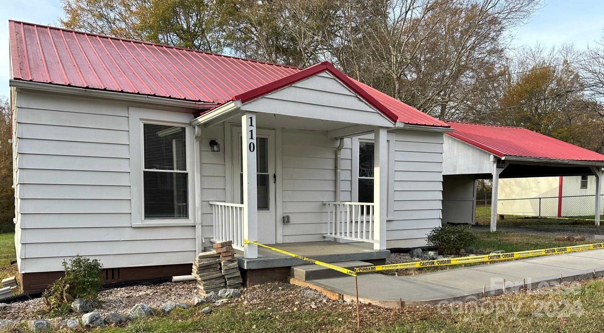 a view of small house with yard