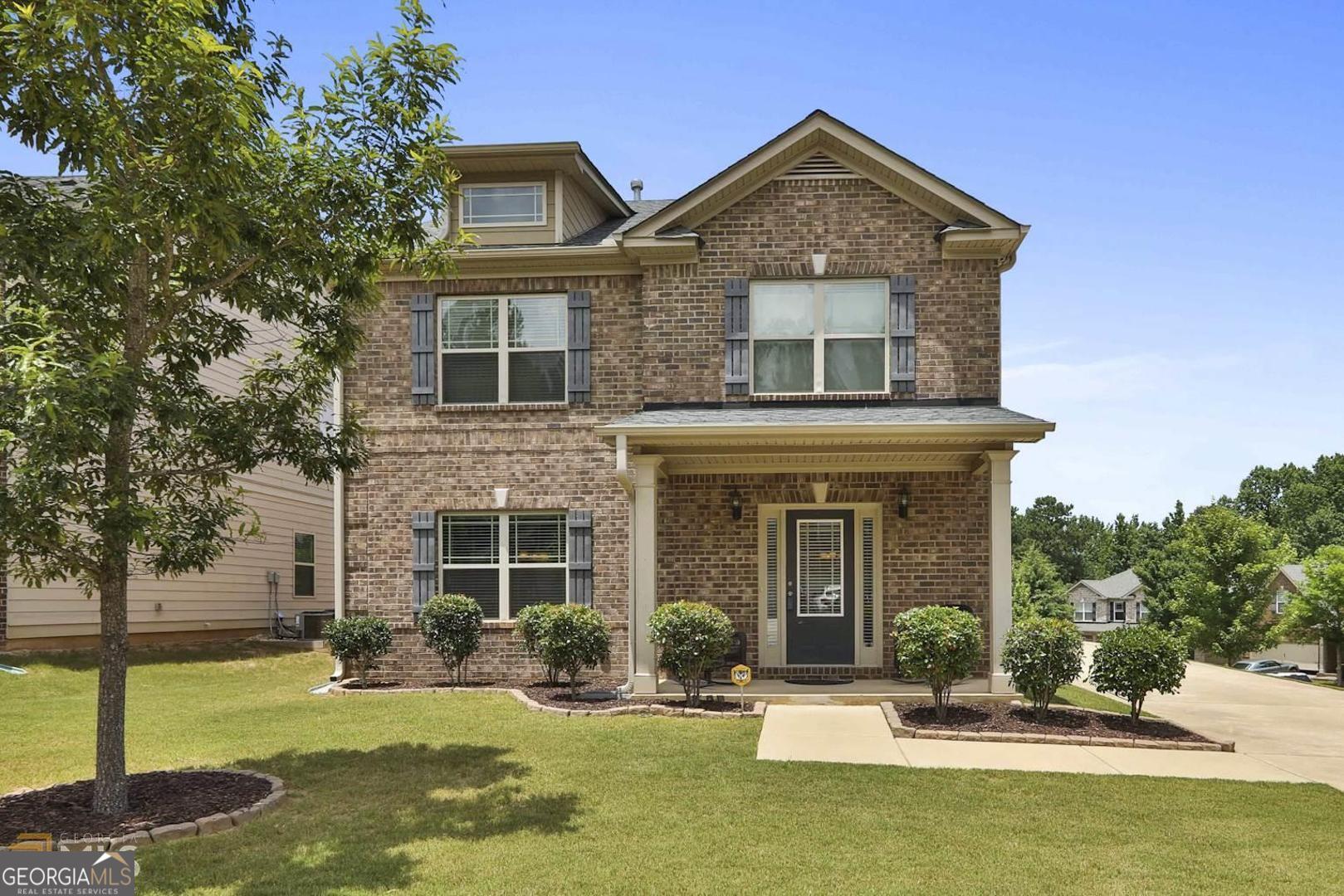 a front view of a house with a yard