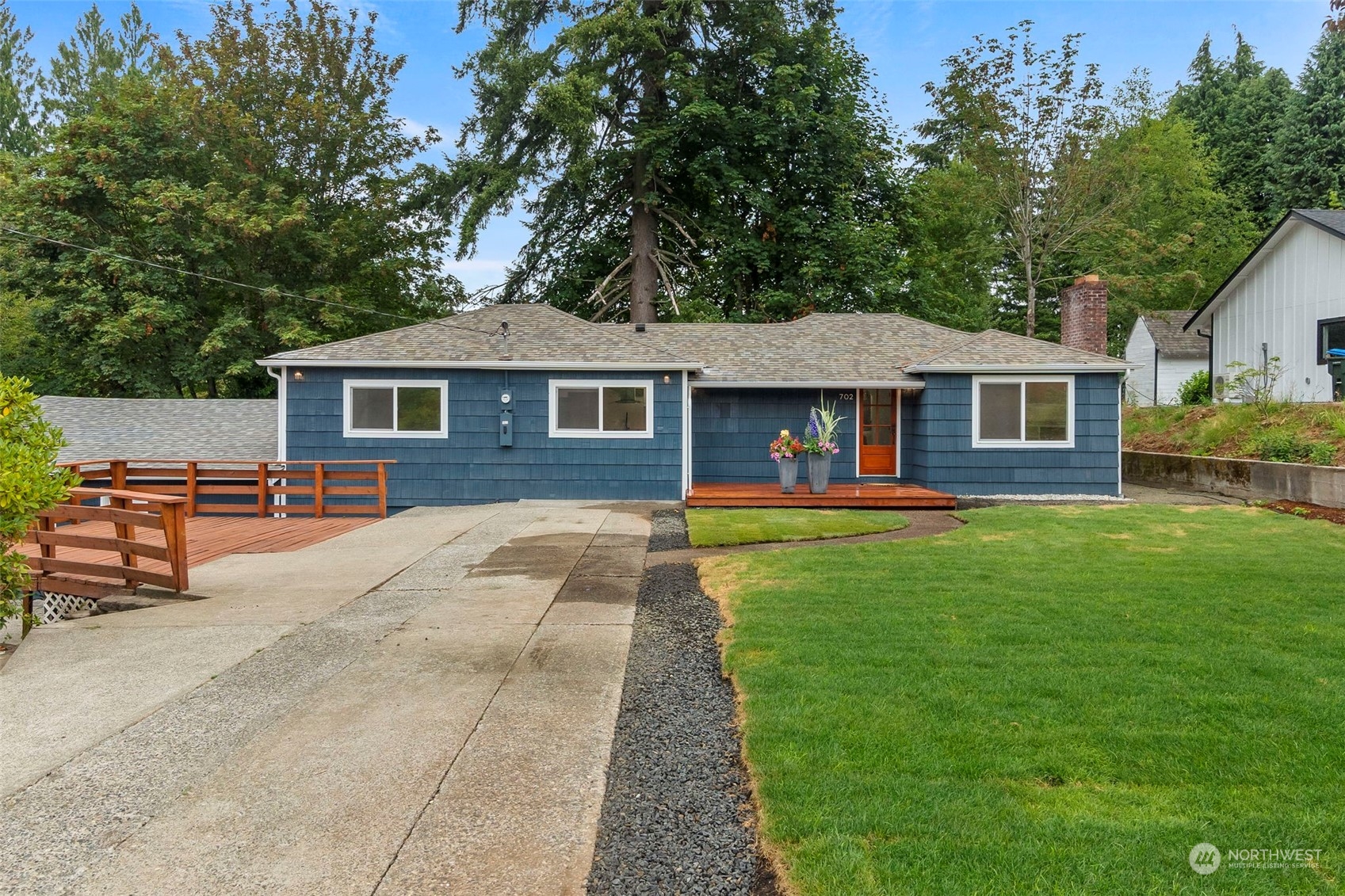 a front view of a house with yard patio and fire pit