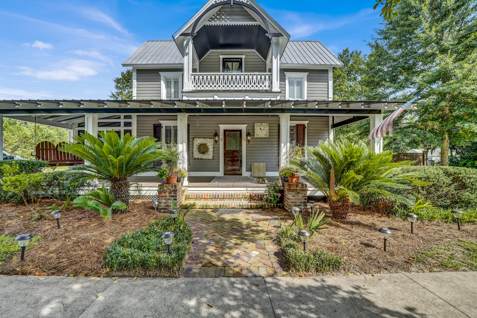 a front view of house with a garden