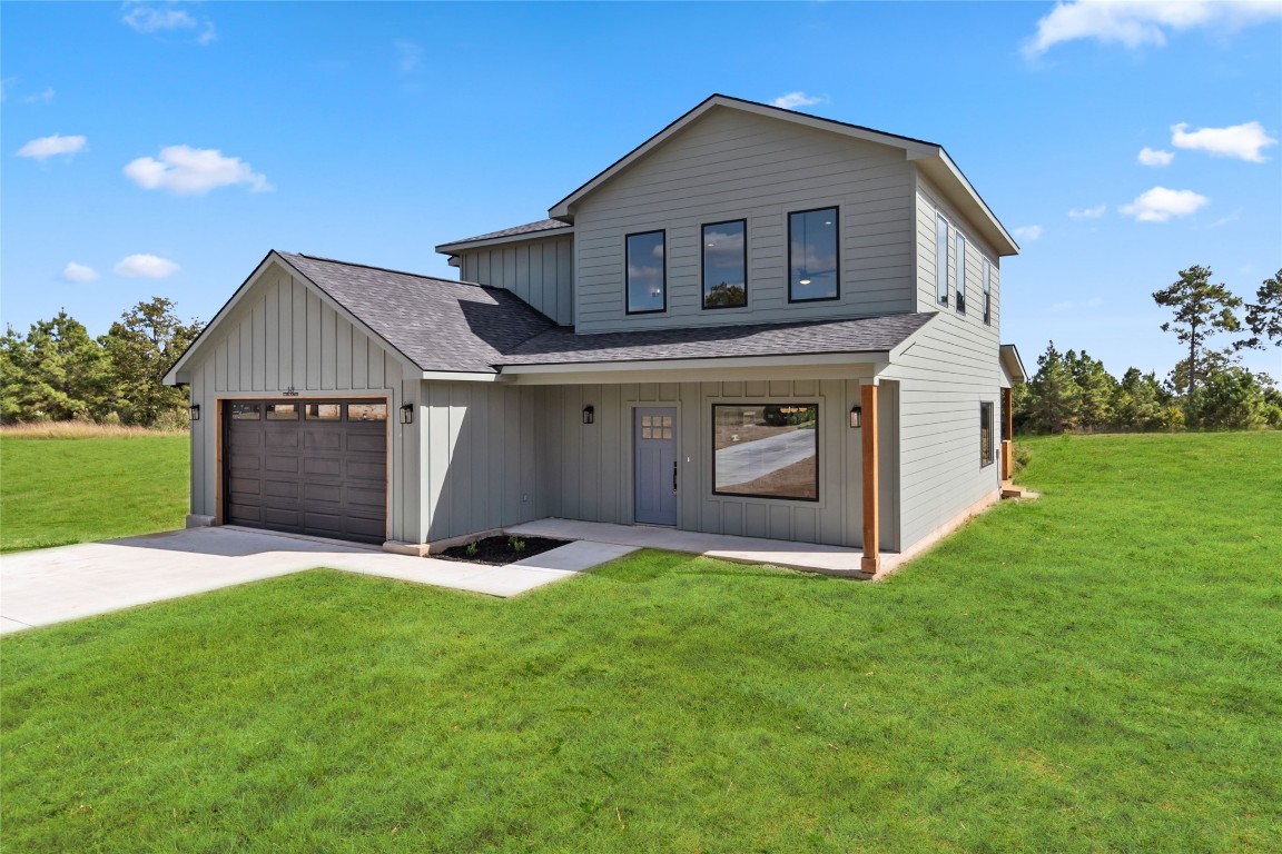 a front view of a house with a yard and garage