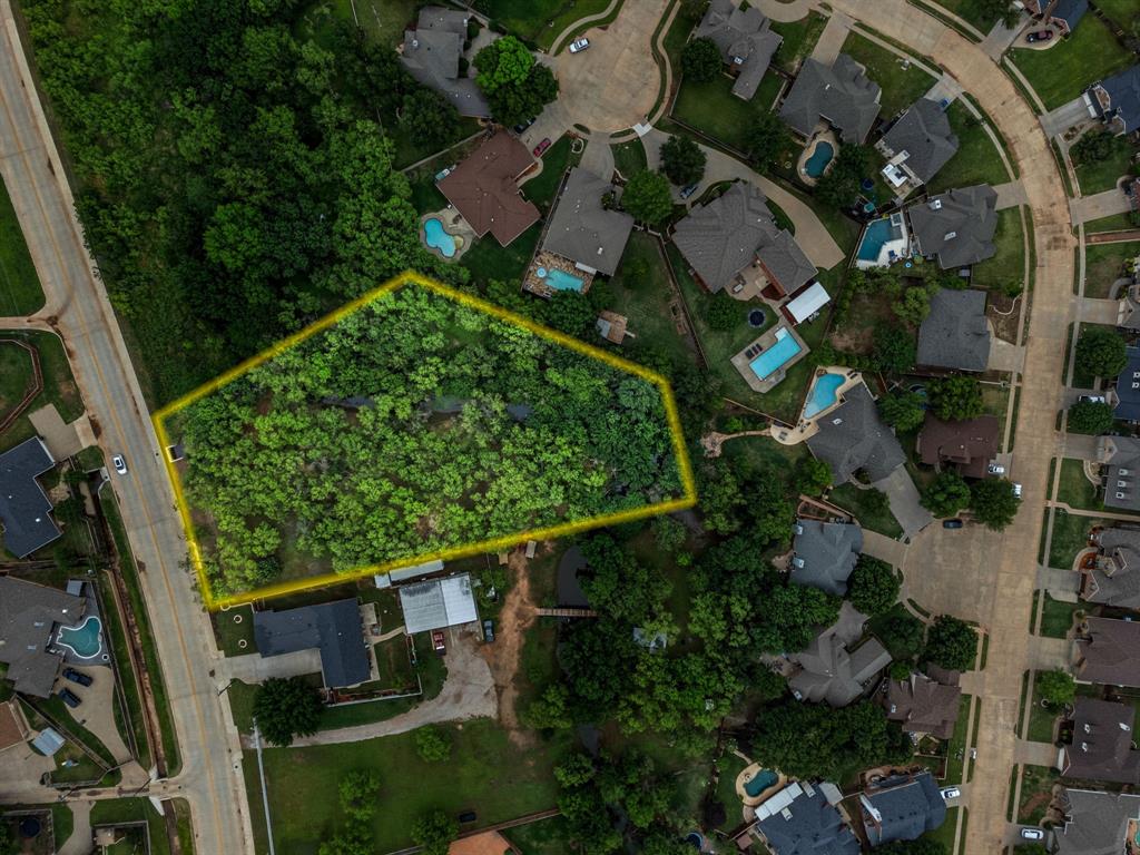 an aerial view of a residential houses with outdoor space and street view