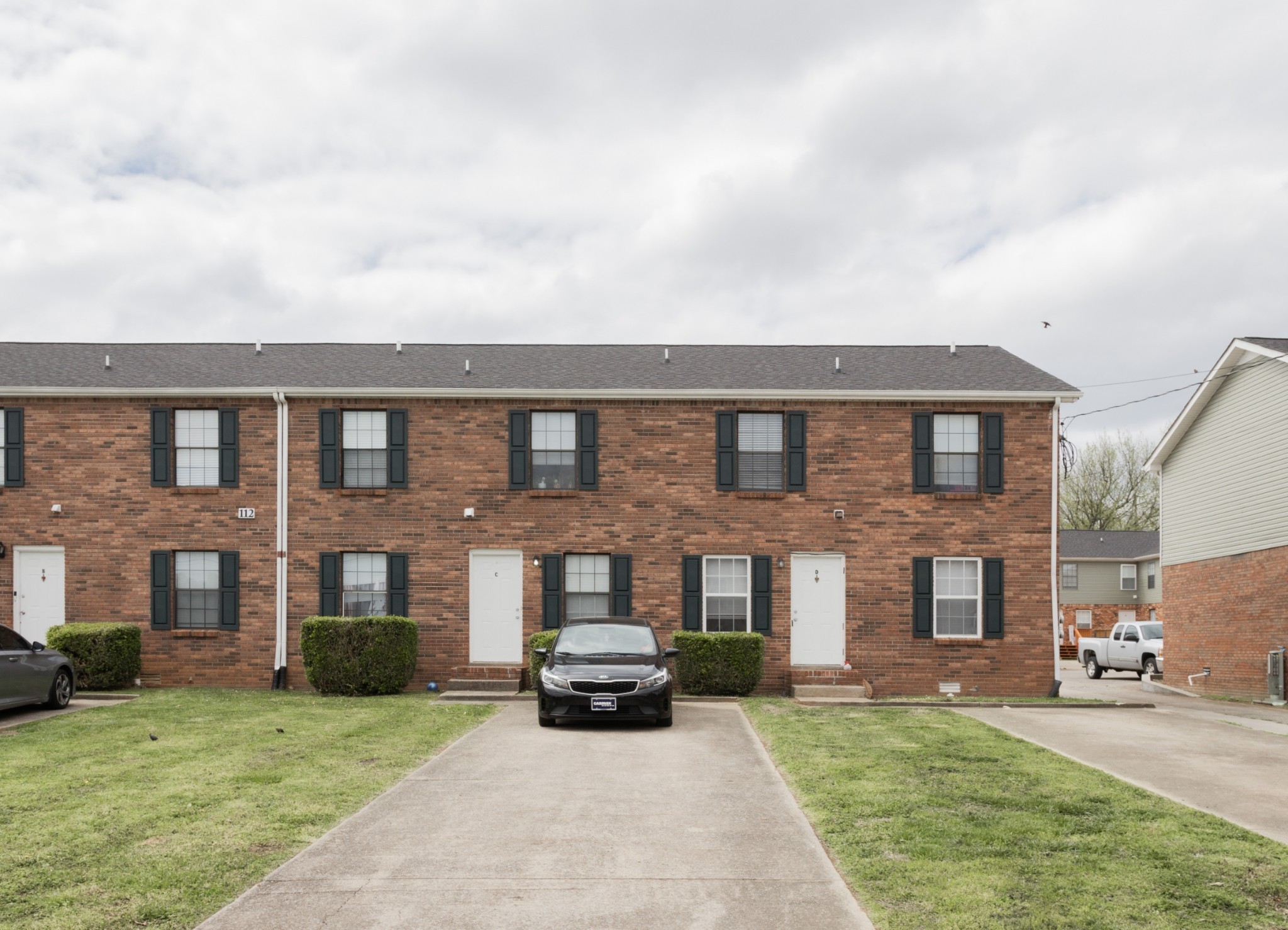 a view of a yard in front of a brick house