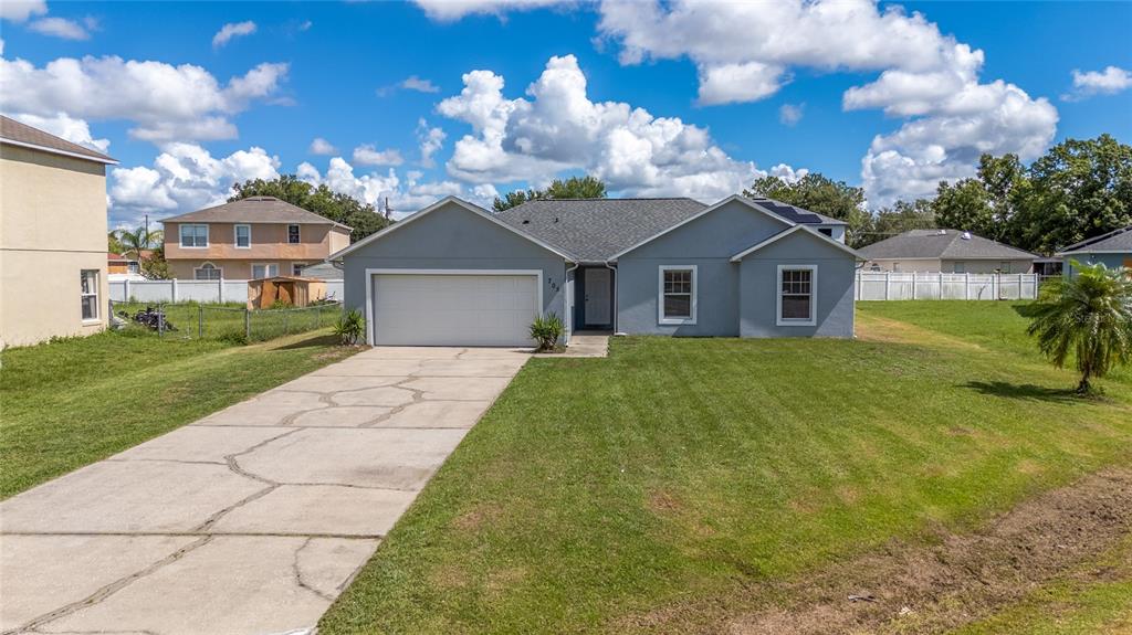 a view of a yard in front of a house with a big yard