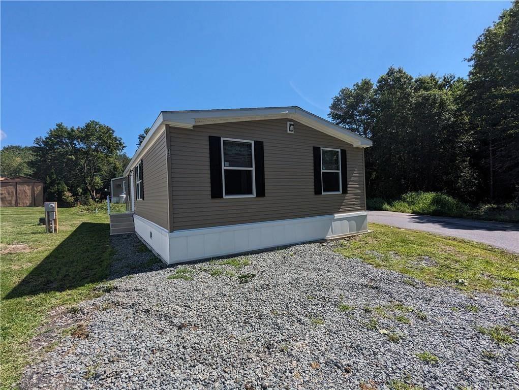 View of side of property featuring a yard