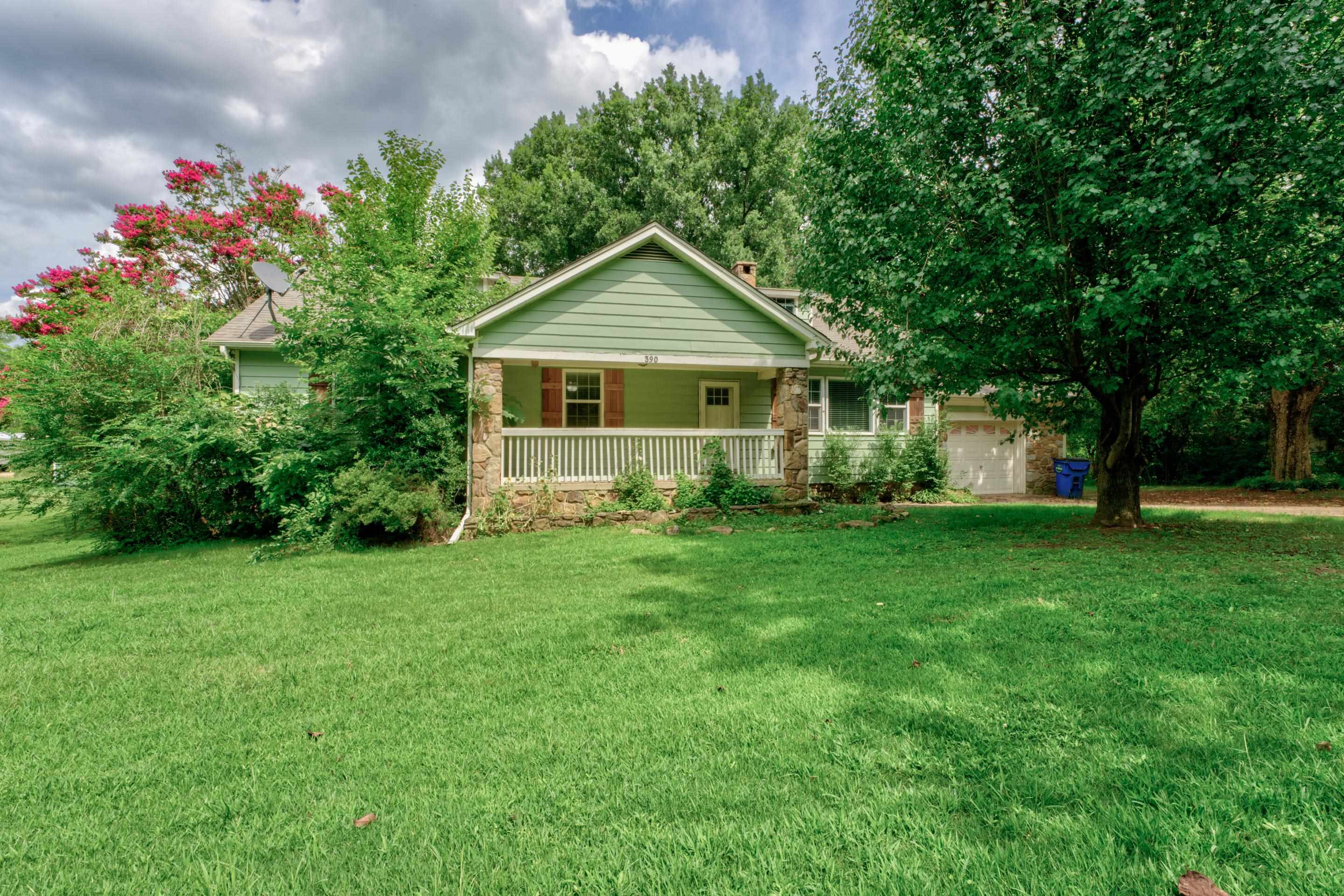 a front view of house with yard and green space