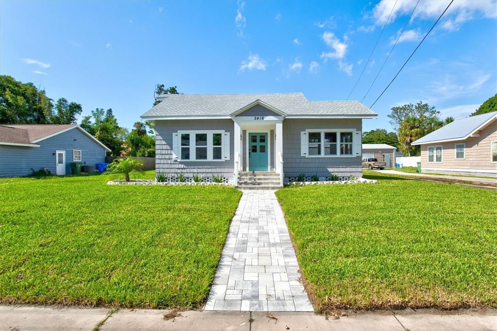 a front view of a house with garden