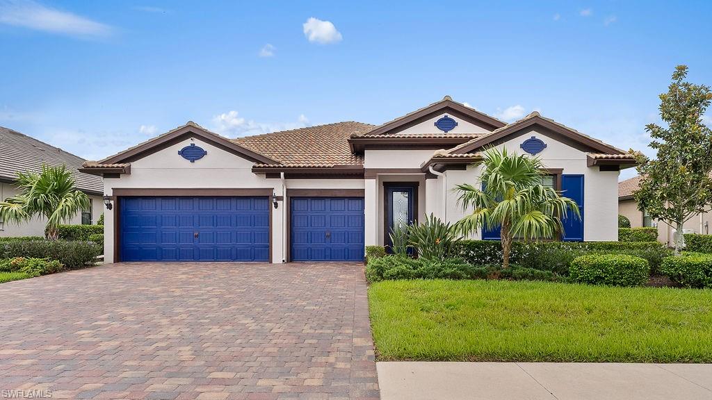 a front view of a house with a yard and garage