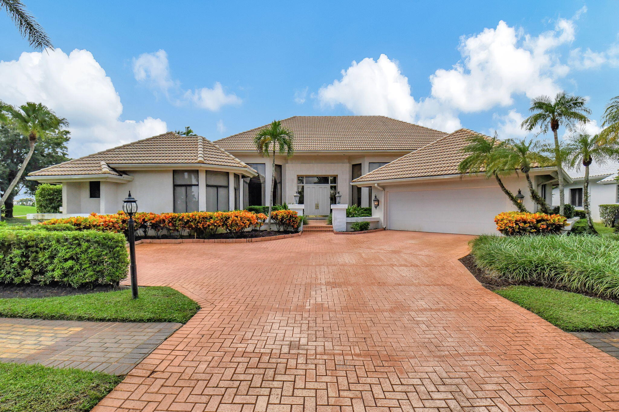 a front view of a house with a garden and plants