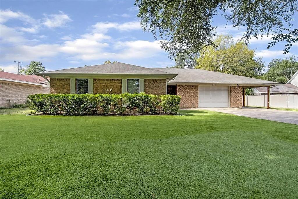 a front view of house with yard and green space