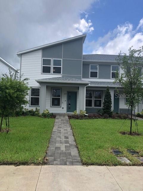 a front view of a house with a garden