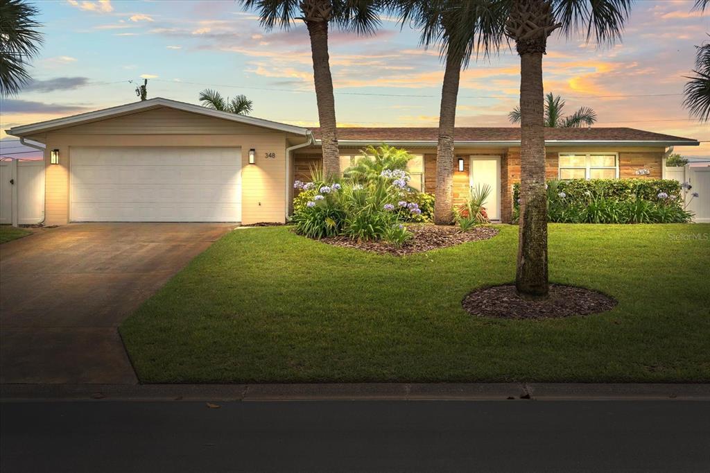 a front view of a house with garden