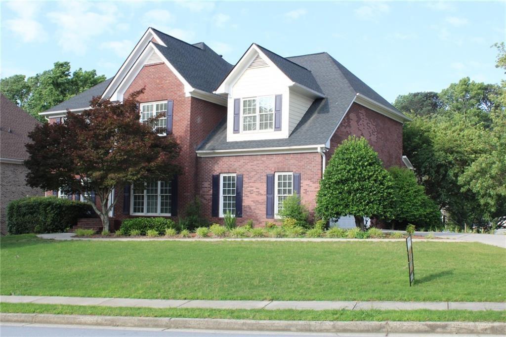 a front view of a house with a yard