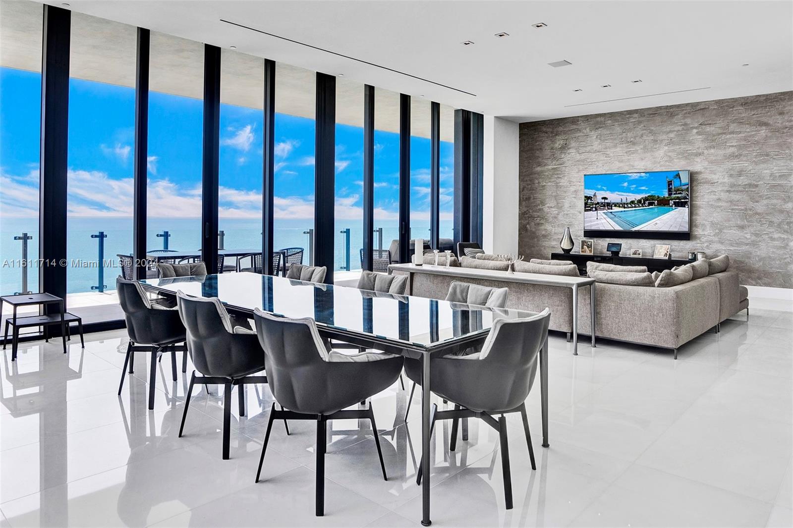 a dining room with furniture and a large window