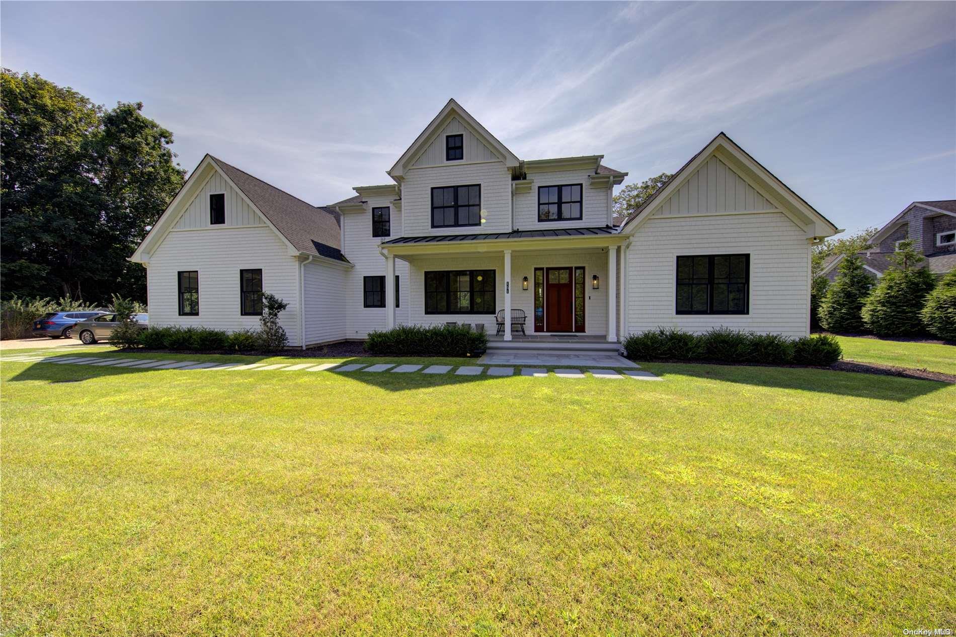 a front view of house with yard and lake view