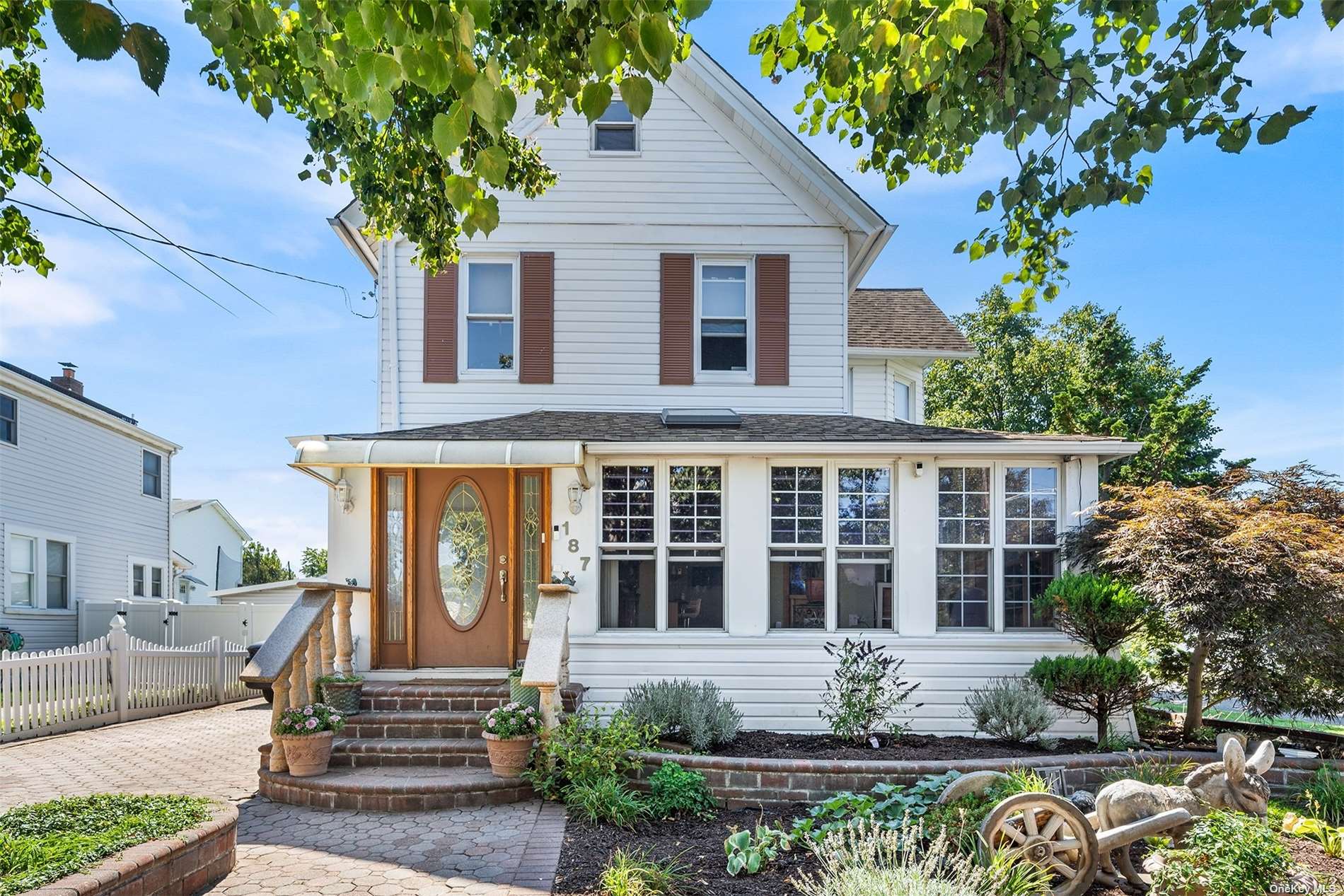 a front view of a house with potted plants