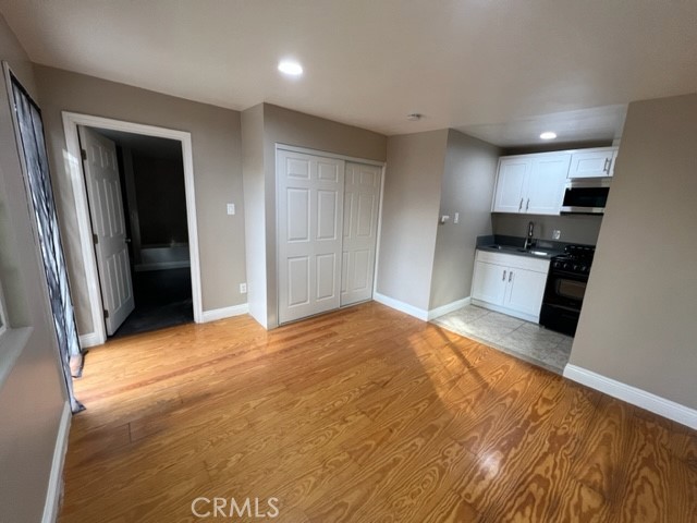 a view of a kitchen with a sink and a refrigerator