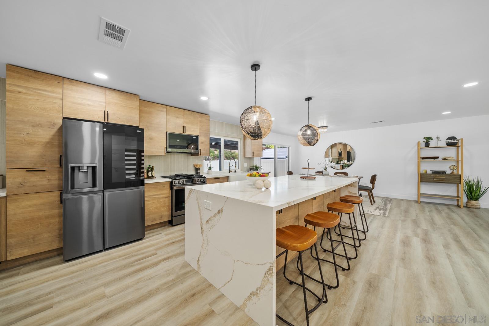 a kitchen with stainless steel appliances kitchen island a refrigerator and a stove